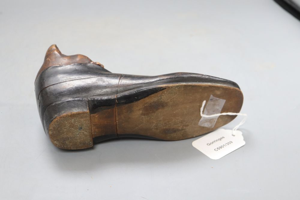 An early 20th century carved wood cat in a shoe inkwell, with hidden compartments, length 20cm